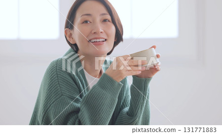 Middle-aged woman holding a mug 131771883