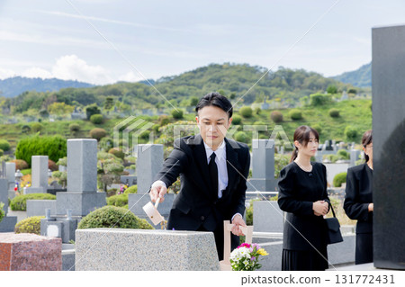 Man cleaning a gravestone 131772431