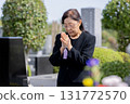 Senior woman visiting a grave 131772570