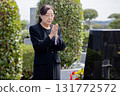 Senior woman visiting a grave 131772572
