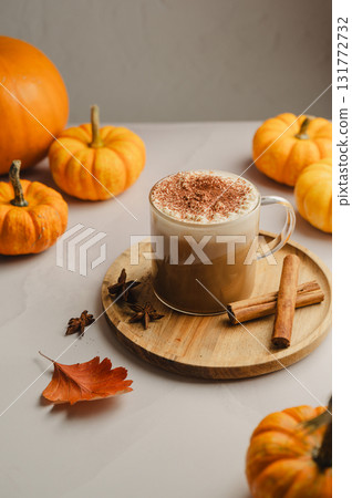 Pumpkin spice latte, coffee drink in glass cup with pumpkins, autumn hot drink Pumpkin spice latte, coffee drink in glass cup with pumpkins, autumn hot drink 131772732