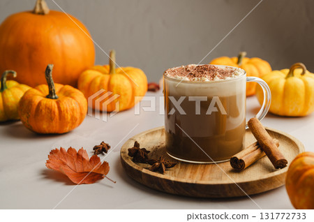 Pumpkin spice latte, coffee drink in glass cup with pumpkins, autumn hot drink Pumpkin spice latte, coffee drink in glass cup with pumpkins, autumn hot drink 131772733