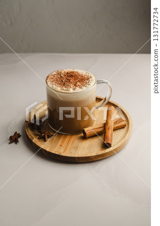 Hot creamy coffee latte drink. Latte coffee drink in glass mug with cinnamon. Hot creamy coffee latte drink. Latte coffee drink in glass mug with cinnamon. 131772734