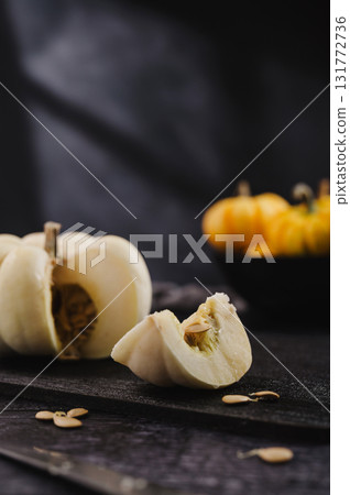 Slice of white pumpkin on dark background, abstract autumn, concept, copy space Slice of white pumpkin on dark background, abstract autumn, concept, copy space 131772736