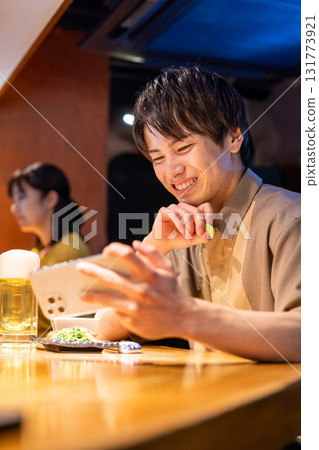 Izakaya: A man enjoying a drink alone Izakaya: A man enjoying a drink alone 131773921