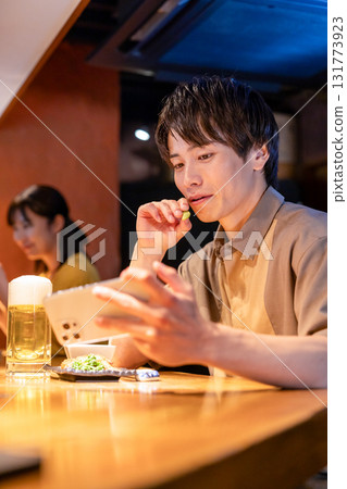 Izakaya: A man enjoying a drink alone Izakaya: A man enjoying a drink alone 131773923