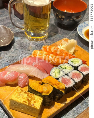 An assortment of fresh sushi, artfully arranged with a variety of toppings and vibrant colors. This traditional Japanese dish combines vinegared rice, seafood, and vegetables for an experience. An assortment of fresh sushi, artfully arranged with a variety of toppings and vibrant colors. This traditional Japanese dish combines vinegared rice, seafood, and vegetables for an experience. 131773993