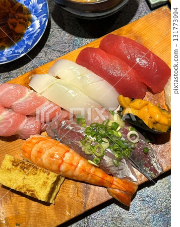An assortment of fresh sushi, artfully arranged with a variety of toppings and vibrant colors. This traditional Japanese dish combines vinegared rice, seafood, and vegetables for an experience. An assortment of fresh sushi, artfully arranged with a variety of toppings and vibrant colors. This traditional Japanese dish combines vinegared rice, seafood, and vegetables for an experience. 131773994