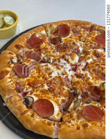 A delicious pizza with a golden crust, melted cheese, and savory toppings. Perfect for food-related designs, menus, or Italian-themed projects, capturing the essence of a classic comfort dish. A delicious pizza with a golden crust, melted cheese, and savory toppings. Perfect for food-related designs, menus, or Italian-themed projects, capturing the essence of a classic comfort dish. 131774060