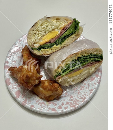 Delicious sandwich filled with fresh ingredients like crisp vegetables, tender meats, and savory spreads, all between two slices of soft bread. Perfect for a quick and satisfying meal. 131774071