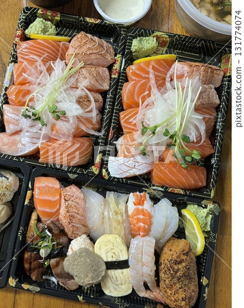 An assortment of fresh sushi, artfully arranged with a variety of toppings and vibrant colors. This traditional Japanese dish combines vinegared rice, seafood, and vegetables for an experience. An assortment of fresh sushi, artfully arranged with a variety of toppings and vibrant colors. This traditional Japanese dish combines vinegared rice, seafood, and vegetables for an experience. 131774074