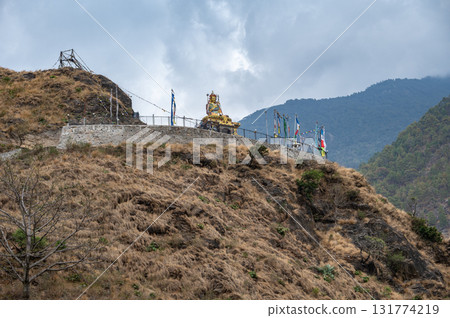 Statue of Guru Rinpoche on the small hill in Syabrubesi a beautiful resident village inside the Langtang National Park of Nepal. Statue of Guru Rinpoche on the small hill in Syabrubesi a beautiful resident village inside the Langtang National Park of Nepal. 131774219
