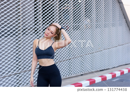 Sport woman begins outdoor workout, stretching for exercise, fit people enjoy sport activity, maintaining healthy body, warm up before training routine, feeling active. Sport woman begins outdoor workout, stretching for exercise, fit people enjoy sport activity, maintaining healthy body, warm up before training routine, feeling active. 131774438