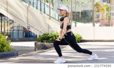 Stretch Asian woman sport exercise workout fit people outdoor urban area, female athlete warm up muscles before training, perform dynamic body stretch for healthy lifestyle. 131774505
