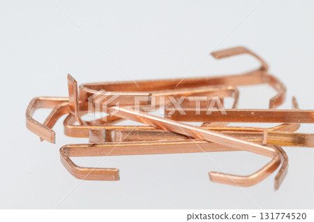 Low-angle view of copper-plated industrial staples Low-angle view of copper-plated industrial staples 131774520