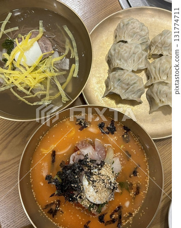 Authentic Pyongyang naengmyeon with chewy buckwheat noodles in cold, clear broth, offering a refreshing and delicate flavor. Perfect for traditional Korean cuisine menus and summer dishes. 131774711