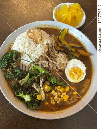 A comforting bowl of Japanese curry, featuring a rich, savory sauce with tender vegetables and chunks of meat, served over fluffy rice. A warm, flavorful dish perfect for any meal. A comforting bowl of Japanese curry, featuring a rich, savory sauce with tender vegetables and chunks of meat, served over fluffy rice. A warm, flavorful dish perfect for any meal. 131774742