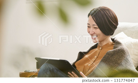 Videophone Woman operating tablet Videophone Woman operating tablet 131774847