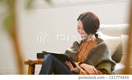 Videophone Woman operating tablet Videophone Woman operating tablet 131774850