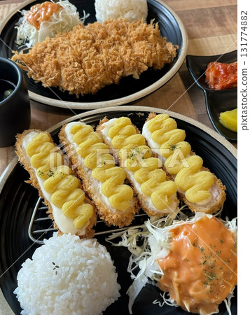 Crispy tonkatsu cutlet stuffed with melted cheese, creating a savory blend of crunch and creaminess. A comforting and satisfying dish with a rich, golden finish. Crispy tonkatsu cutlet stuffed with melted cheese, creating a savory blend of crunch and creaminess. A comforting and satisfying dish with a rich, golden finish. 131774882