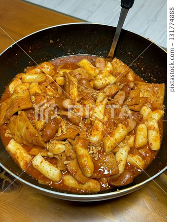 Spicy and savory rabokki combining chewy tteokbokki rice cakes and springy ramyeon noodles in a rich, bold sauce, delivering the perfect Korean comfort food experience in every satisfying bite. 131774888