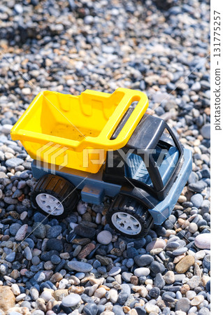 A toy truck is sitting on a pile of rocks A toy truck is sitting on a pile of rocks 131775257