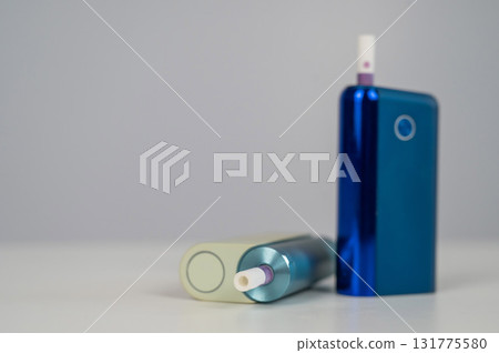 Two electronic cigarettes on a white background. Tobacco heating systems. 131775580