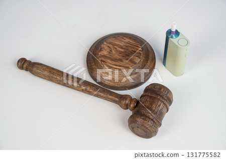 Judge's gavel and e-cigarette. Smoking ban. Tobacco heating systems.  131775582