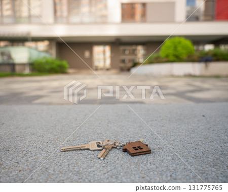 Keys with House Keychain Left on Paved Path.  131775765