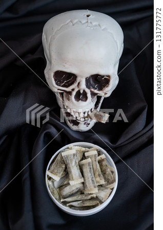 Skull Chewing Tobacco on Black Cloth.  131775772