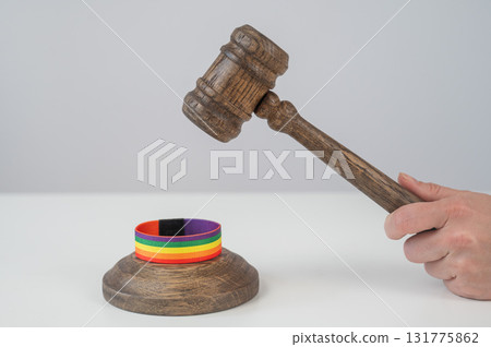 Judge hits gavel on rainbow bracelet. Judge hits gavel on rainbow bracelet. 131775862