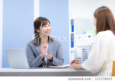 Business woman serving customers at the counter Business woman serving customers at the counter 131776025