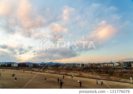 Family enjoying kite flying in the evening 131776076