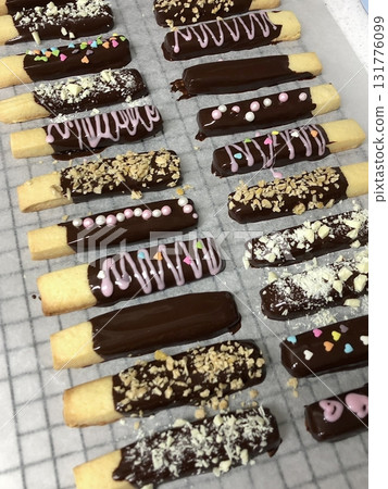 Pepero sticks coated with chocolate and sometimes topped with nuts or sprinkles. A sweet and crunchy treat, perfect for sharing or gifting on special occasions. Pepero sticks coated with chocolate and sometimes topped with nuts or sprinkles. A sweet and crunchy treat, perfect for sharing or gifting on special occasions. 131776099