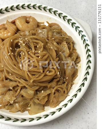 Creamy and rich spaghetti coated in a luscious white sauce, offering a smooth and savory flavor perfect for a comforting and satisfying meal. 131776151