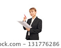 A woman in a suit holding a red pen 131776286