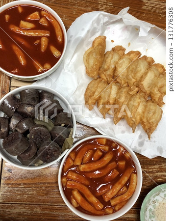 Bunsik, a popular Korean street food, features comforting and savory dishes like tteokbokki (spicy rice cakes), odeng (fish cake skewers), and kimbap (seaweed rice rolls). Perfect for quick meals. Bunsik, a popular Korean street food, features comforting and savory dishes like tteokbokki (spicy rice cakes), odeng (fish cake skewers), and kimbap (seaweed rice rolls). Perfect for quick meals. 131776308