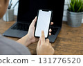 Hands of a woman using a  smartphone mockup at his desk, Mobile phone blank screen for editing graphics. 131776520