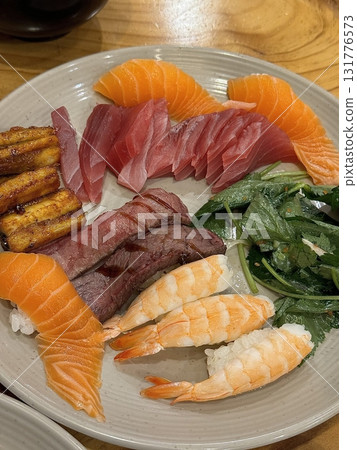 An assortment of fresh sushi, artfully arranged with a variety of toppings and vibrant colors. This traditional Japanese dish combines vinegared rice, seafood, and vegetables for an experience. An assortment of fresh sushi, artfully arranged with a variety of toppings and vibrant colors. This traditional Japanese dish combines vinegared rice, seafood, and vegetables for an experience. 131776573