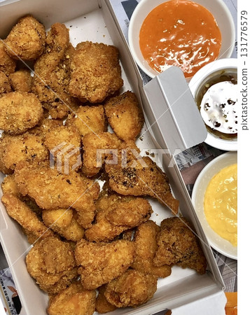Crispy Korean fried chicken, perfectly glazed with a sweet and spicy sauce. Ideal for food photography and menus, showcasing the irresistible crunch and flavor of this beloved dish. 131776579