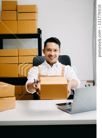 Young man running online store Startup small business SME, using smartphone or tablet taking receive and checking online purchase shopping order Young man running online store Startup small business SME, using smartphone or tablet taking receive and checking online purchase shopping order 131776816