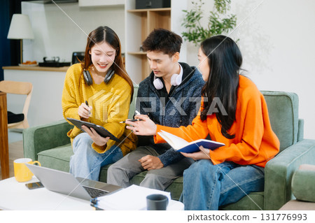 vibrant teamwork, creativity, and learning with young adults using laptops and headphones  in cozy 131776993