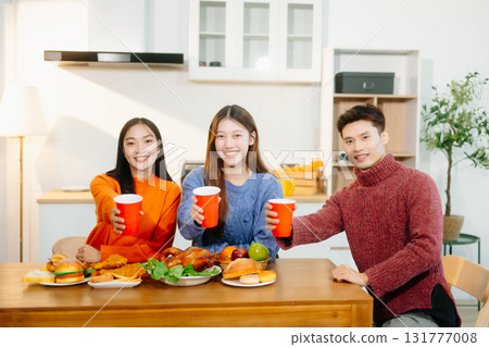 Young Asian friend having, enjoy evening party together at home. Attractive young man and woman having fun Young Asian friend having, enjoy evening party together at home. Attractive young man and woman having fun 131777008