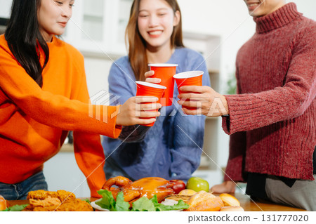 Young Asian friend having, enjoy evening party together at home. Attractive young man and woman having fun Young Asian friend having, enjoy evening party together at home. Attractive young man and woman having fun 131777020