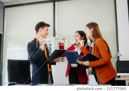 Professional teamwork as business colleagues engage in strategy, planning, and discussion 131777068