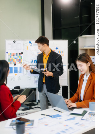Office colleagues have a casual discussion. During a meeting in a conference room, a group of business teem Office colleagues have a casual discussion. During a meeting in a conference room, a group of business teem 131777098