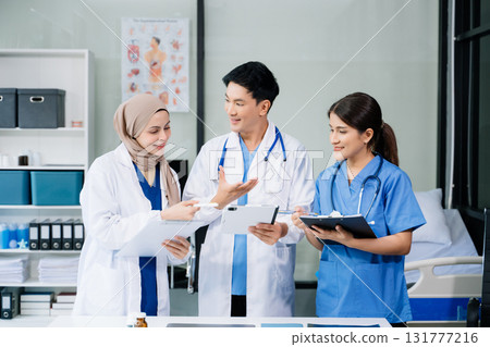 Doctors analyzing results or diagnosis of patient in clinic. Teamwork, medical and healthcare workers in discussion and research on desk in hospital Doctors analyzing results or diagnosis of patient in clinic. Teamwork, medical and healthcare workers in discussion and research on desk in hospital 131777216