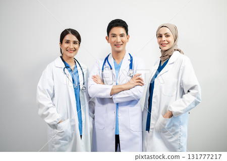 Successful team of medical doctors looking at camera and smiling while standin. Health, professional and people team Successful team of medical doctors looking at camera and smiling while standin. Health, professional and people team 131777217