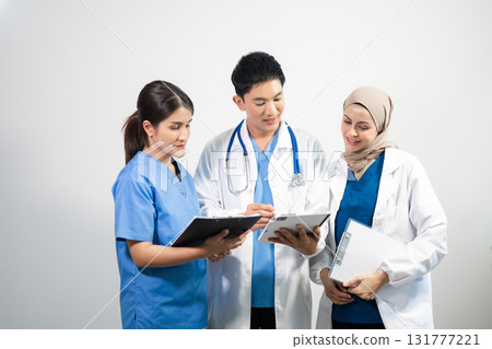 Successful team of medical doctors looking at camera and smiling while standin. Health, professional and people team in white background Successful team of medical doctors looking at camera and smiling while standin. Health, professional and people team in white background 131777221