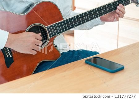 Hand of a man playing the guitar 131777277